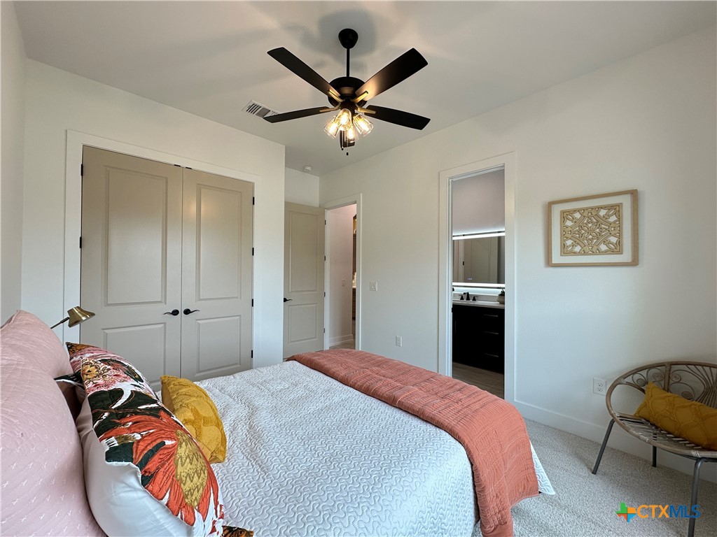 430 Dos Rios Drive Belton, TX 76513 - Photo 28 of 48 a bedroom with a bed and a chandelier