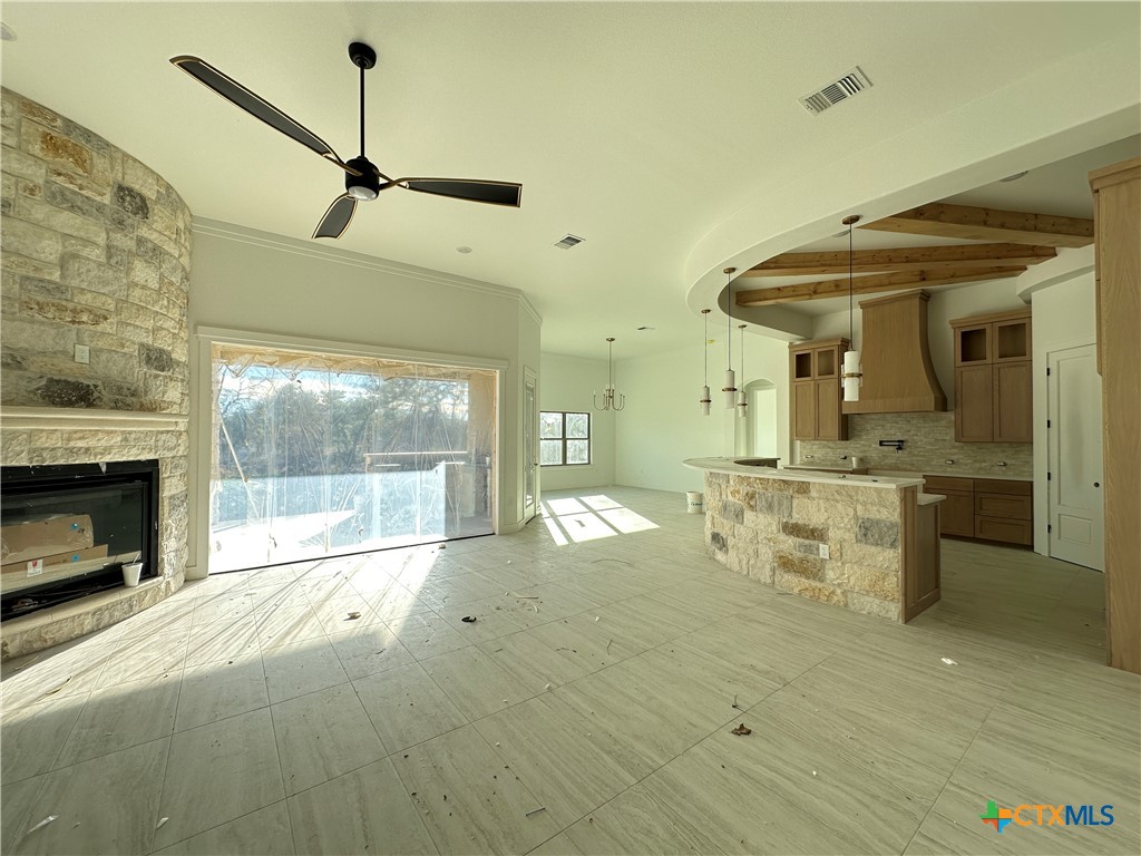 430 Dos Rios Drive Belton, TX 76513 - Photo 3 of 29 a large white kitchen with a large window a fireplace and a counter space