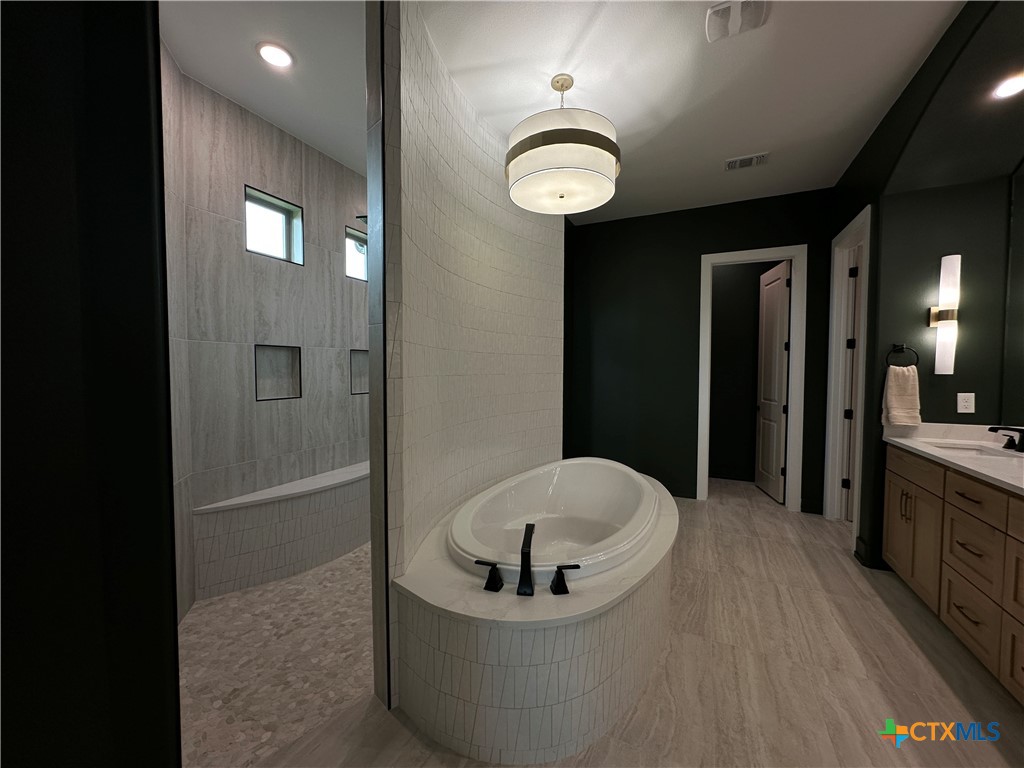 430 Dos Rios Drive Belton, TX 76513 - Photo 36 of 48 a bathroom with a bathtub and shower