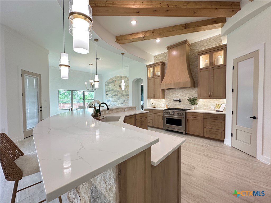 430 Dos Rios Drive Belton, TX 76513 - Photo 10 of 48 a large kitchen with a large counter top a sink stainless steel appliances and cabinets