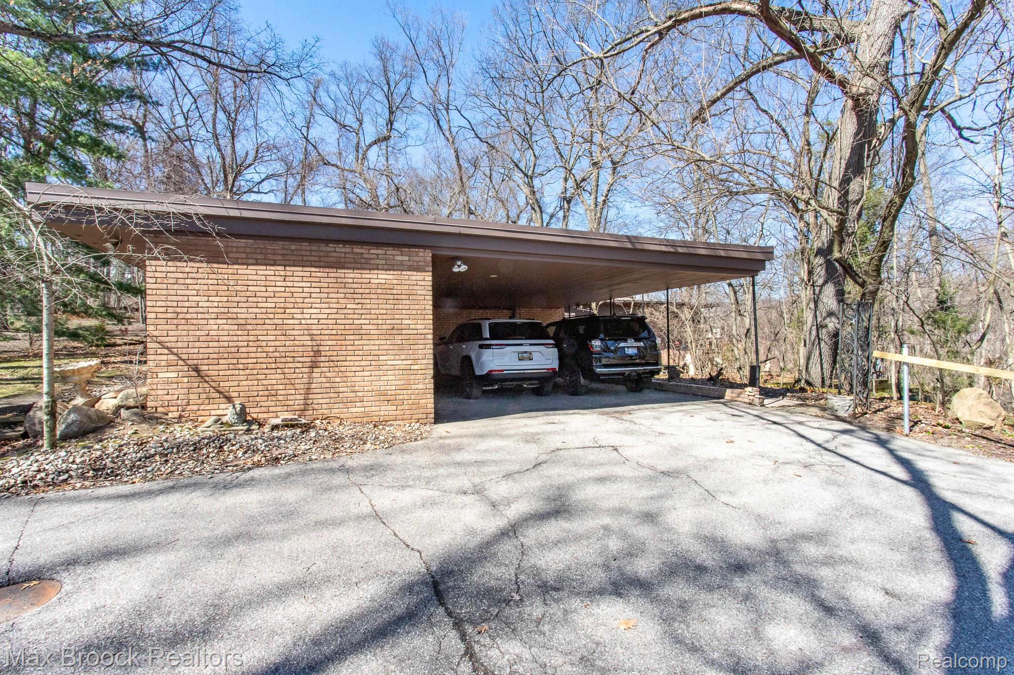 30875 Franklin Road Franklin, MI 48025 - Photo 8 of 86 View of parking featuring driveway and a carport