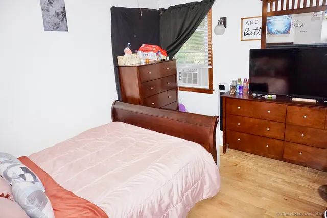 a bedroom with a bed and a flat screen tv