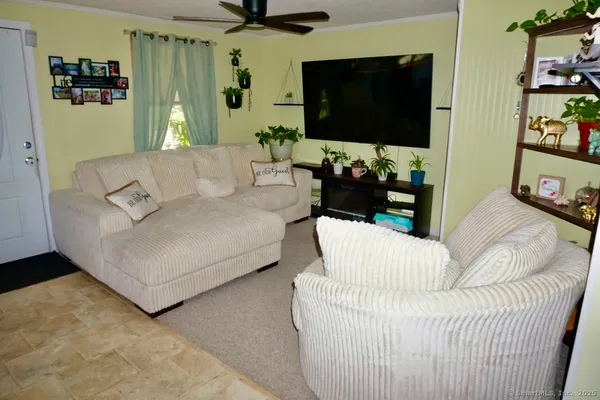 a living room with furniture and a flat screen tv