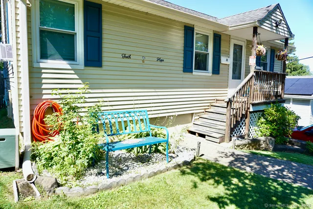 a backyard of a house with a garden and outdoor seating