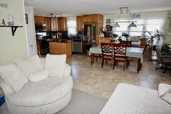 a living room with lots of furniture and kitchen view