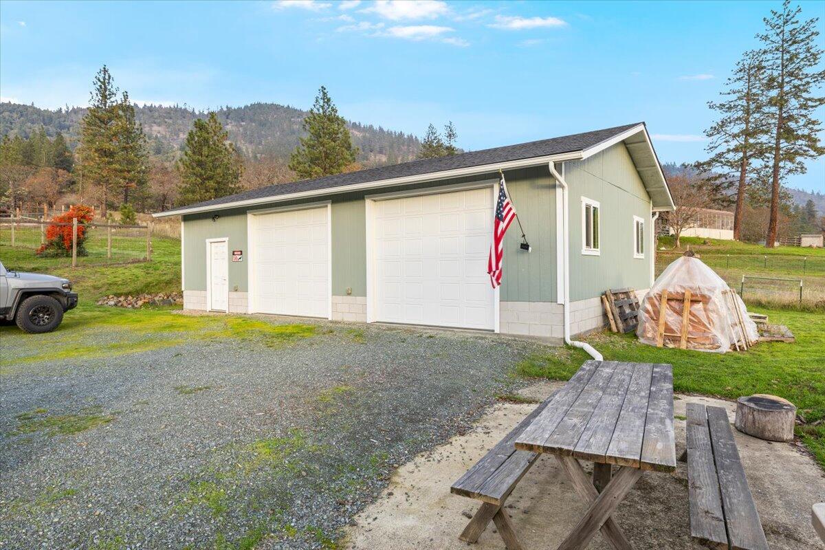 1360 Oxyoke Road Grants Pass, OR 97526 - Photo 29 of 39 a view of backyard of house and car parked
