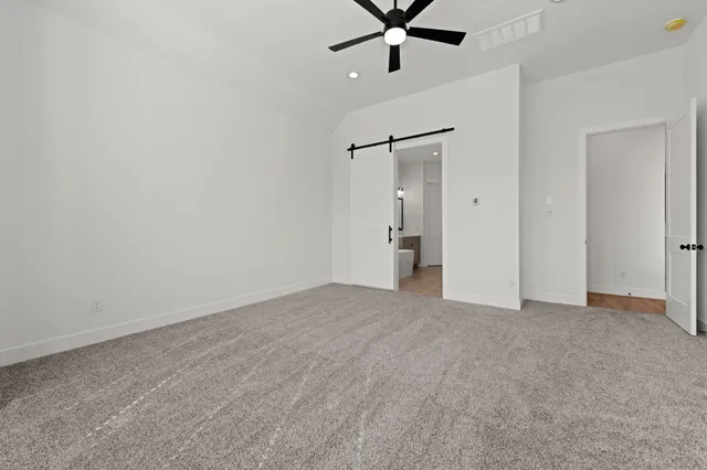 an empty room with a empty space and a ceiling fan