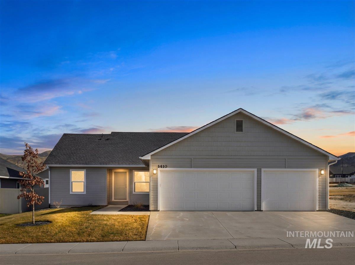1410 Regency Way Emmett, ID 83617 - Photo 1 of 46 Single story home with concrete driveway, an attached garage, and a front lawn
