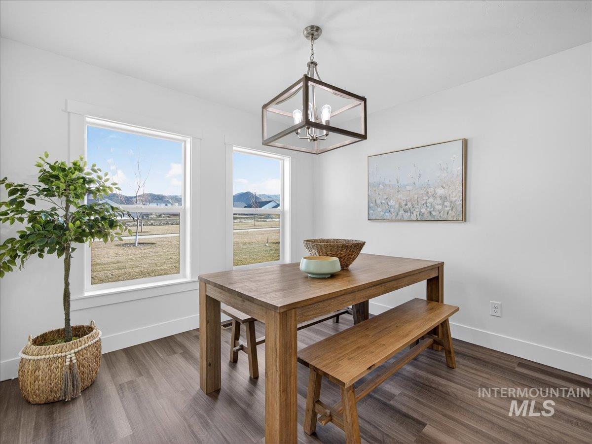 1410 Regency Way Emmett, ID 83617 - Photo 15 of 46 Dining area featuring suspended lighting, dark wood finished floors, and a mountain view