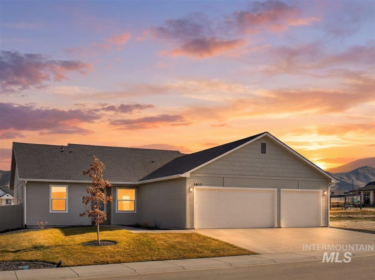1410 Regency Way Emmett, ID 83617 - Photo 2 of 46 View of front of house with concrete driveway, a lawn, and a garage