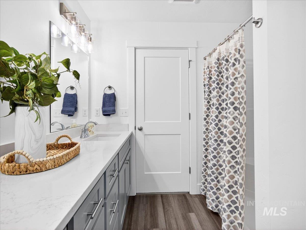 1410 Regency Way Emmett, ID 83617 - Photo 22 of 46 Full bathroom with dark wood-style floors, vanity, and a shower with curtain