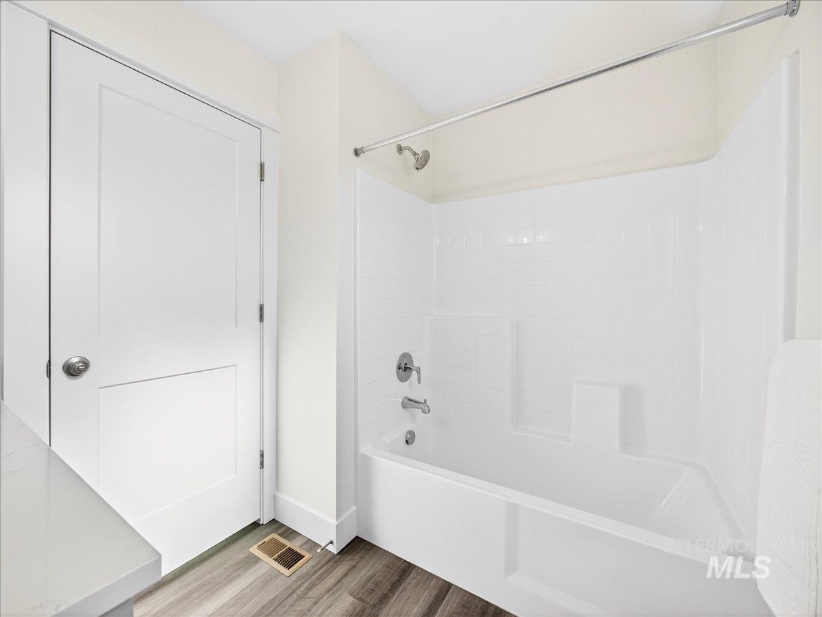 1410 Regency Way Emmett, ID 83617 - Photo 31 of 46 Full bath featuring washtub / shower combination and light wood-style flooring