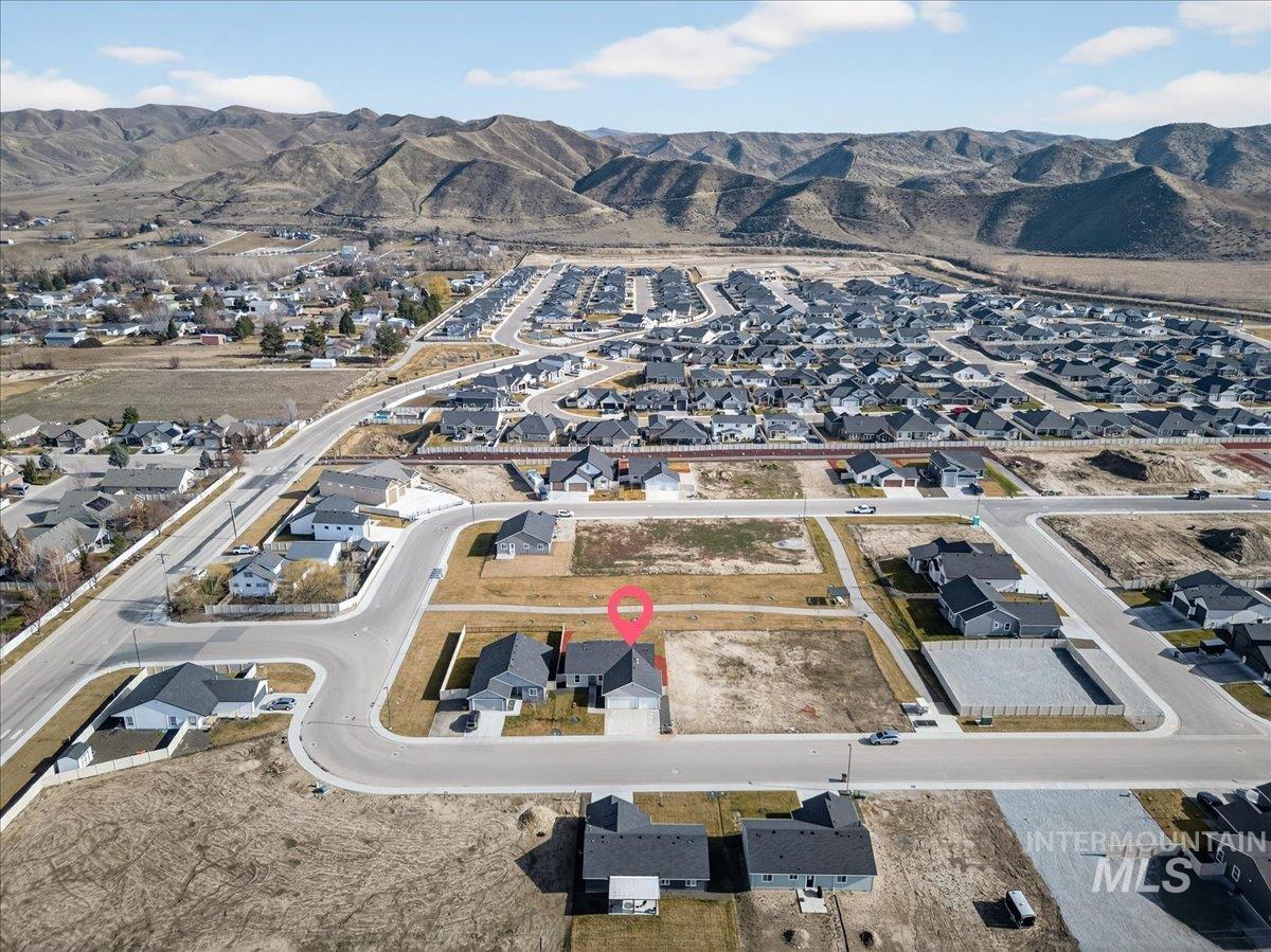 1410 Regency Way Emmett, ID 83617 - Photo 43 of 46 Aerial view of property and surrounding area with nearby suburban area and a mountain backdrop