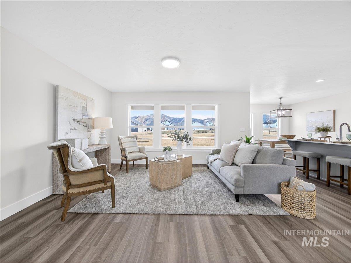 1410 Regency Way Emmett, ID 83617 - Photo 7 of 46 Living area with wood finished floors and hanging lights