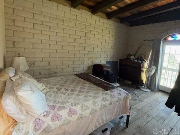 a bedroom with a bed and a television