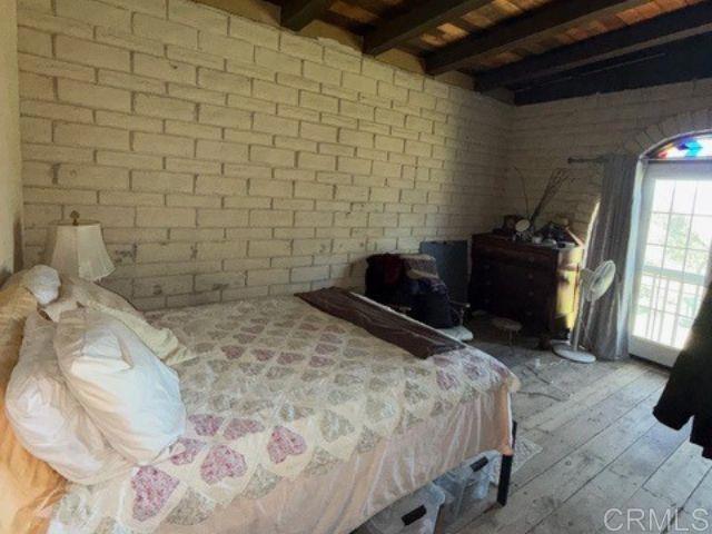 20042 Deerhorn Valley Road Jamul, CA 91935 - Photo 13 of 15 a bedroom with a bed and a television