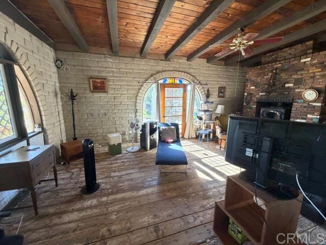 20042 Deerhorn Valley Road Jamul, CA 91935 - Photo 7 of 15 a living room with fireplace furniture and a wooden floor