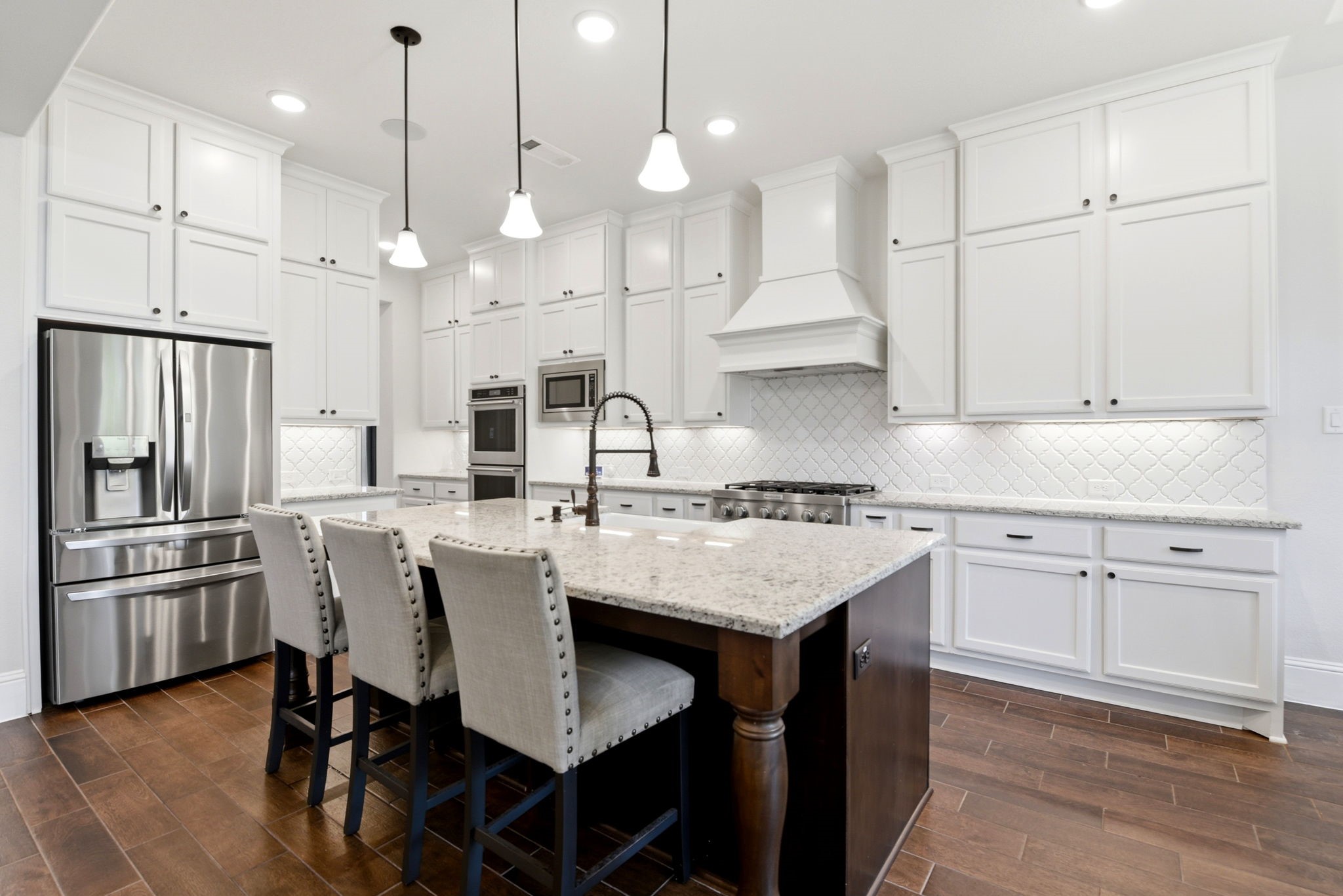 10062 South Goshawk Trail Conroe, TX 77385 - Photo 10 of 43 a kitchen with kitchen island granite countertop a sink a center island and stainless steel appliances