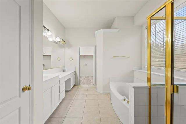 a bathroom with a tub sink and mirror