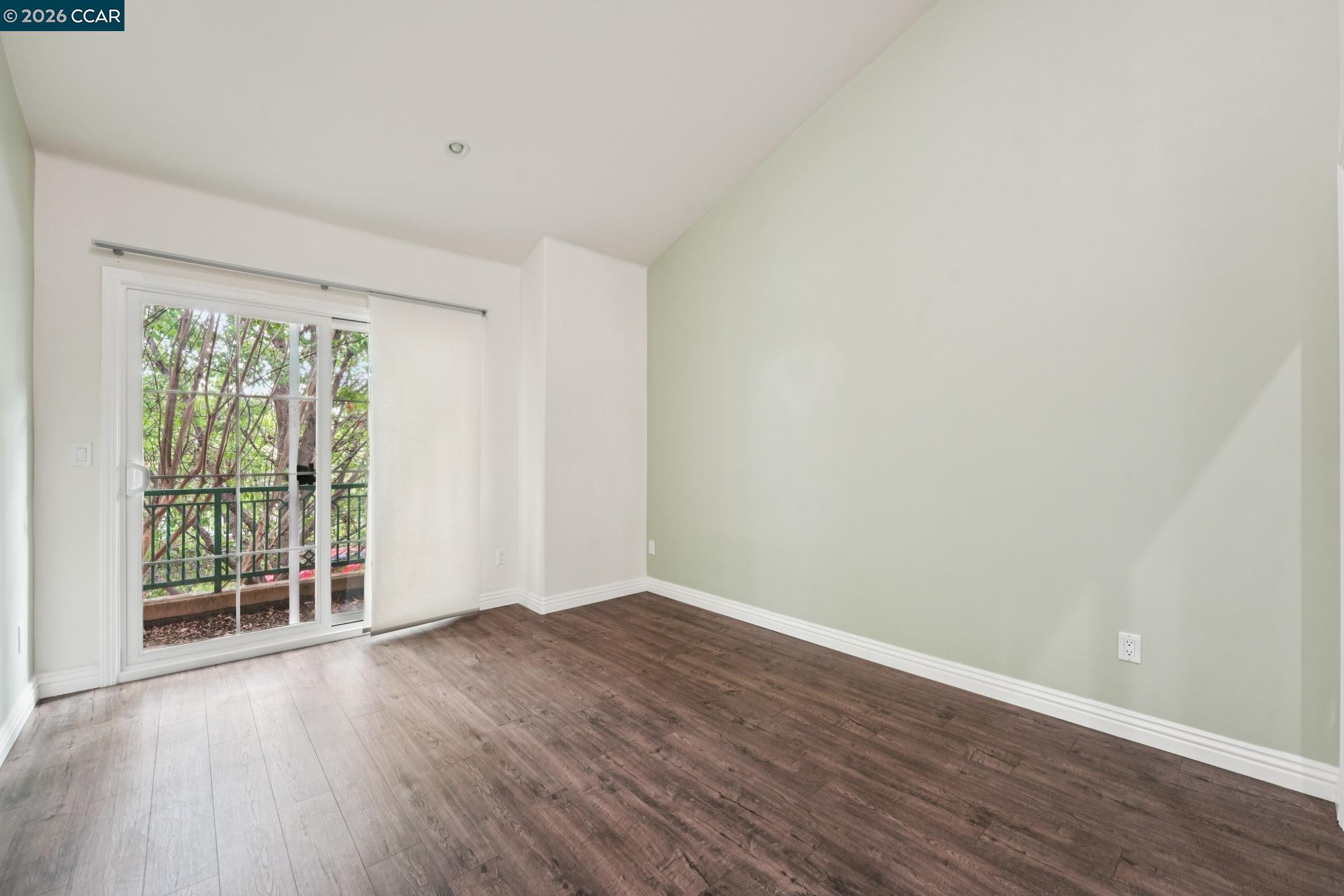 1539 Geary Road, Unit C Walnut Creek, CA 94597 - Photo 15 of 21 an empty room with wooden floor and windows