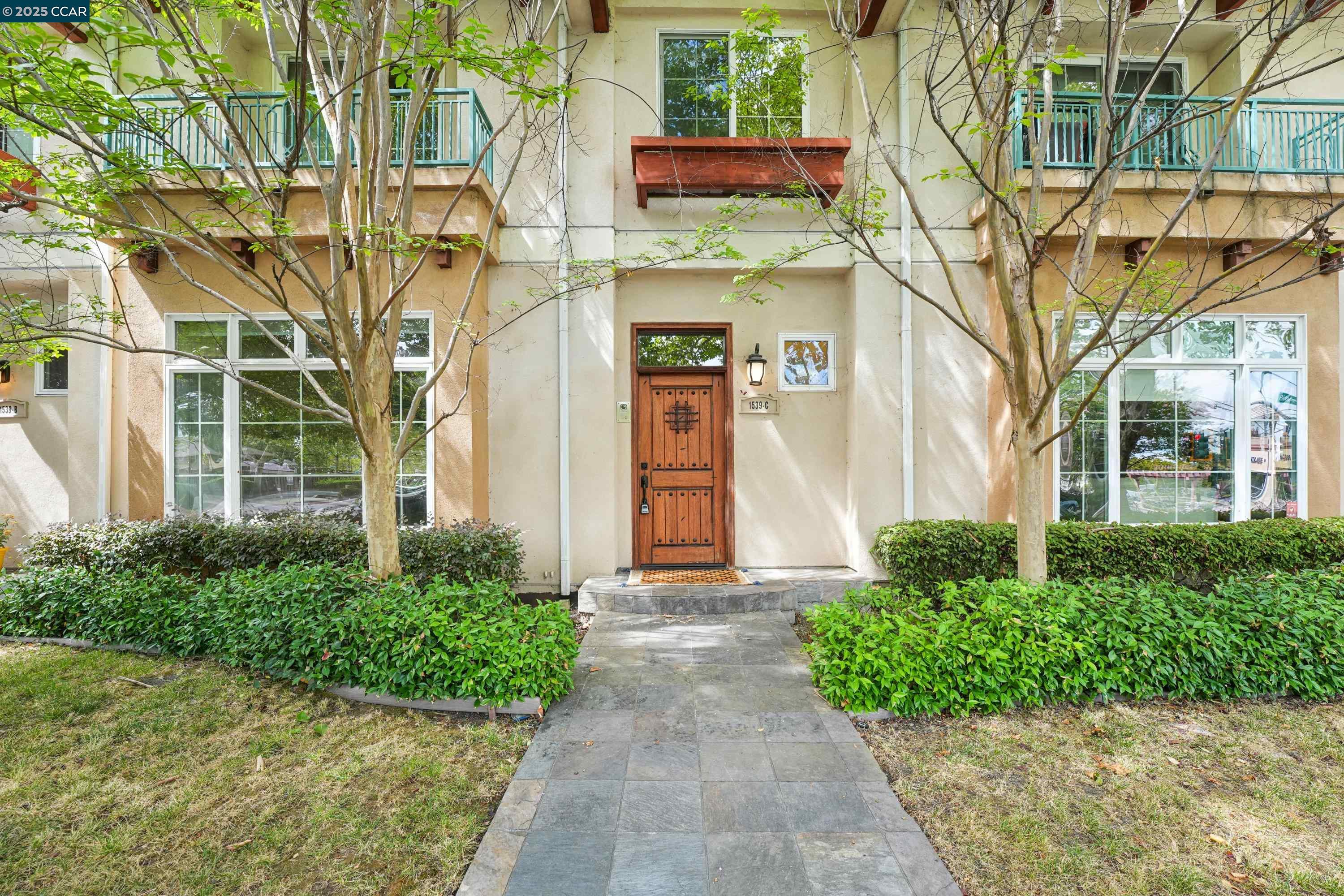 1539 Geary Road, Unit C Walnut Creek, CA 94597 - Photo 20 of 21 front view of a brick house with a large tree
