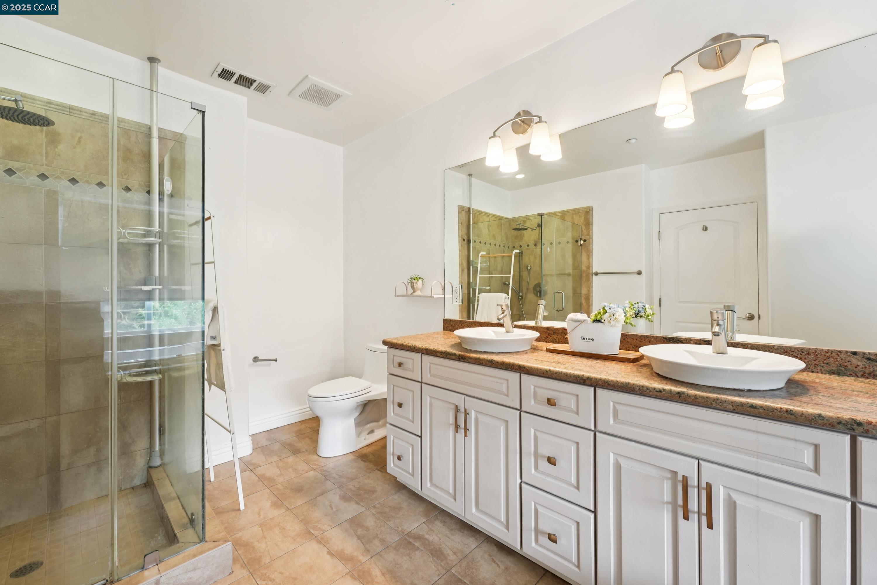 1539 Geary Road, Unit C Walnut Creek, CA 94597 - Photo 10 of 21 a bathroom with a double vanity sink mirror and shower
