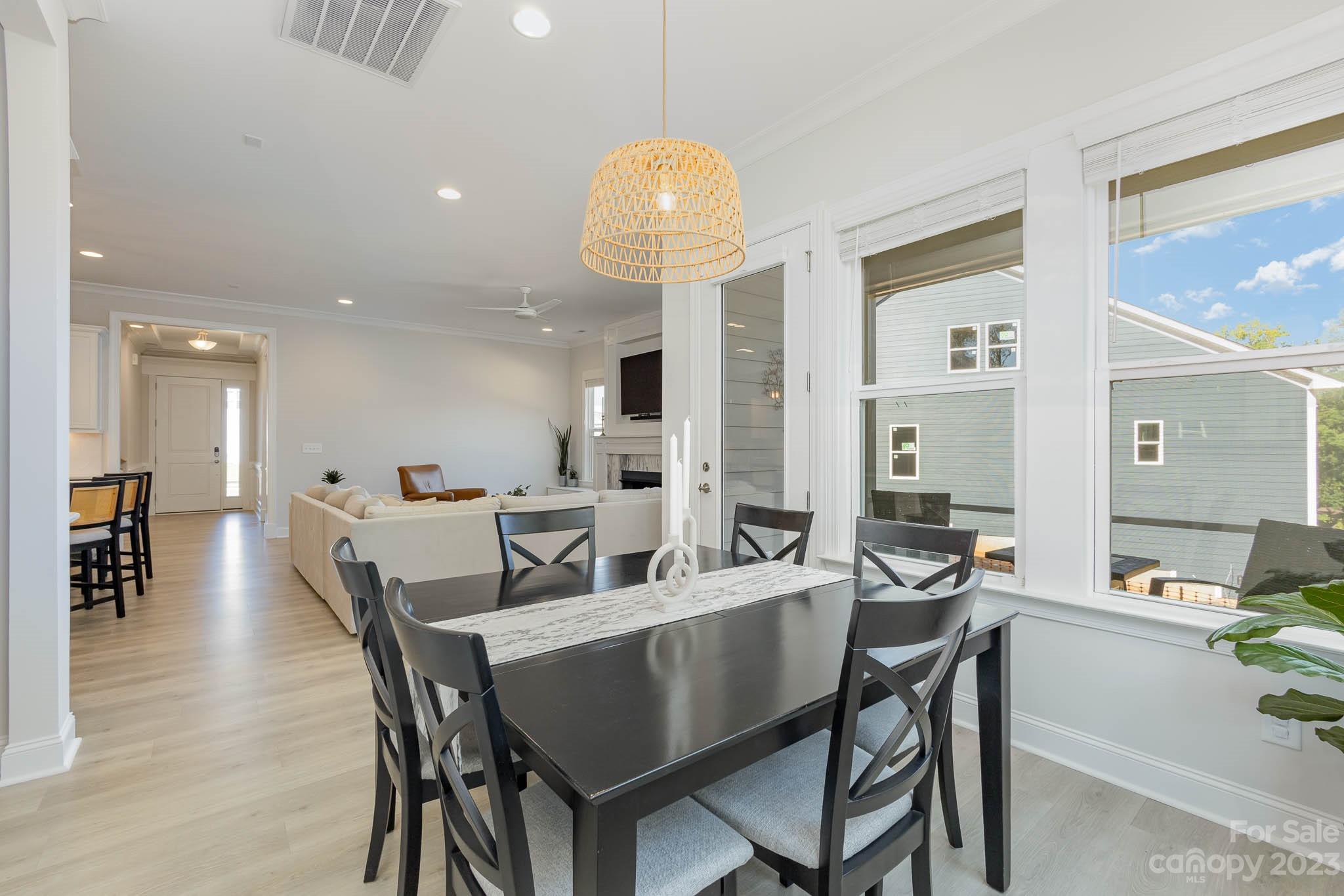 17150 Sand Bank Road Charlotte, NC 28278 - Photo 11 of 32 a dining room with furniture and wooden floor