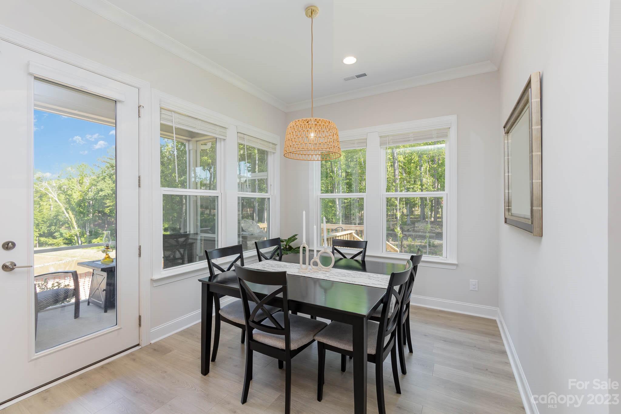 17150 Sand Bank Road Charlotte, NC 28278 - Photo 12 of 32 a dining room with furniture a chandelier and wooden floor