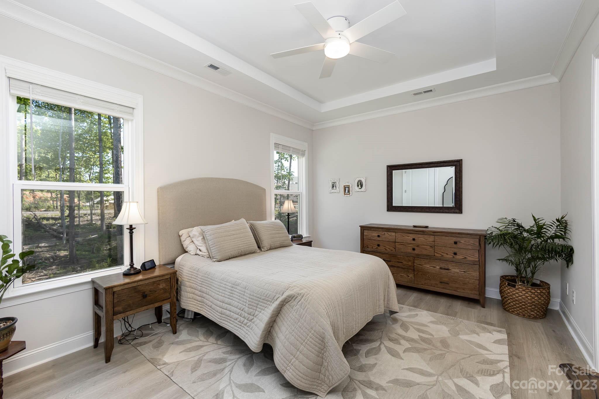 17150 Sand Bank Road Charlotte, NC 28278 - Photo 13 of 32 a bedroom with a bed and a chandelier