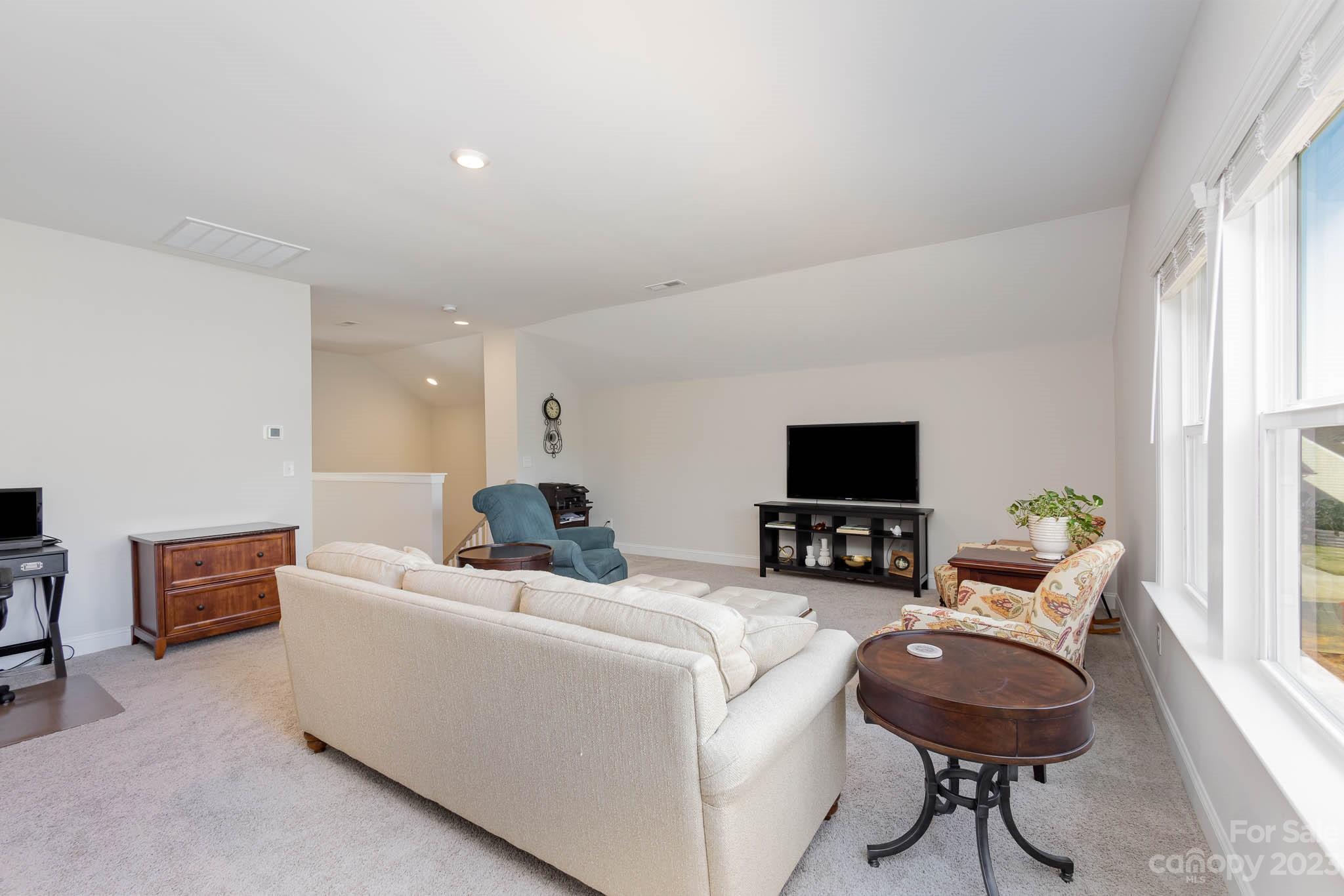 17150 Sand Bank Road Charlotte, NC 28278 - Photo 24 of 32 a living room with furniture and a flat screen tv