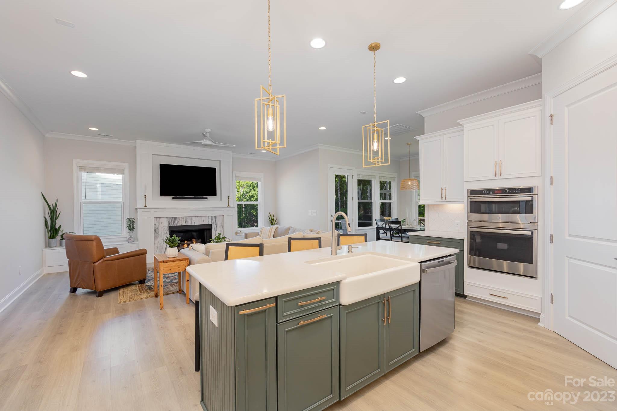 17150 Sand Bank Road Charlotte, NC 28278 - Photo 6 of 32 a large kitchen with kitchen island a stove a sink a oven and a refrigerator with wooden floor