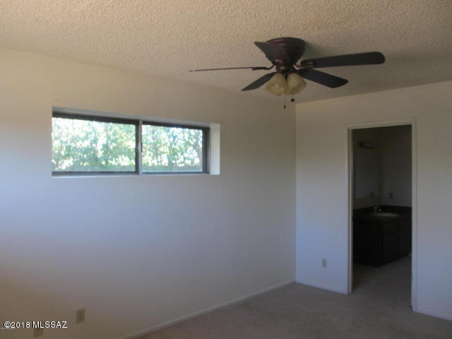 1160 Avenida Leon Rio Rico, AZ 85648 - Photo 23 of 47 an empty room with a window and a ceiling fan