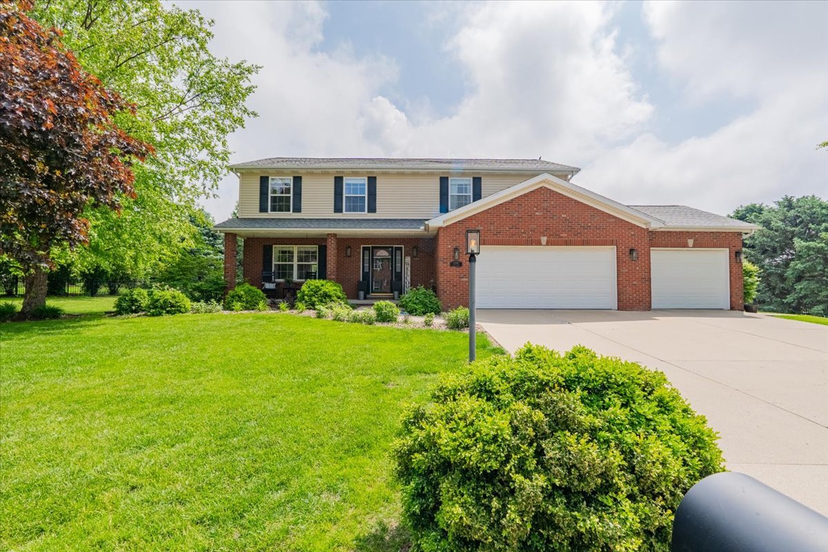 13561 Buck Road Bloomington, IL 61705 - Photo 1 of 43 a front view of a house with garden