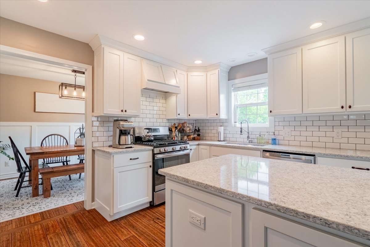 13561 Buck Road Bloomington, IL 61705 - Photo 12 of 43 a kitchen with granite countertop white cabinets and white appliances
