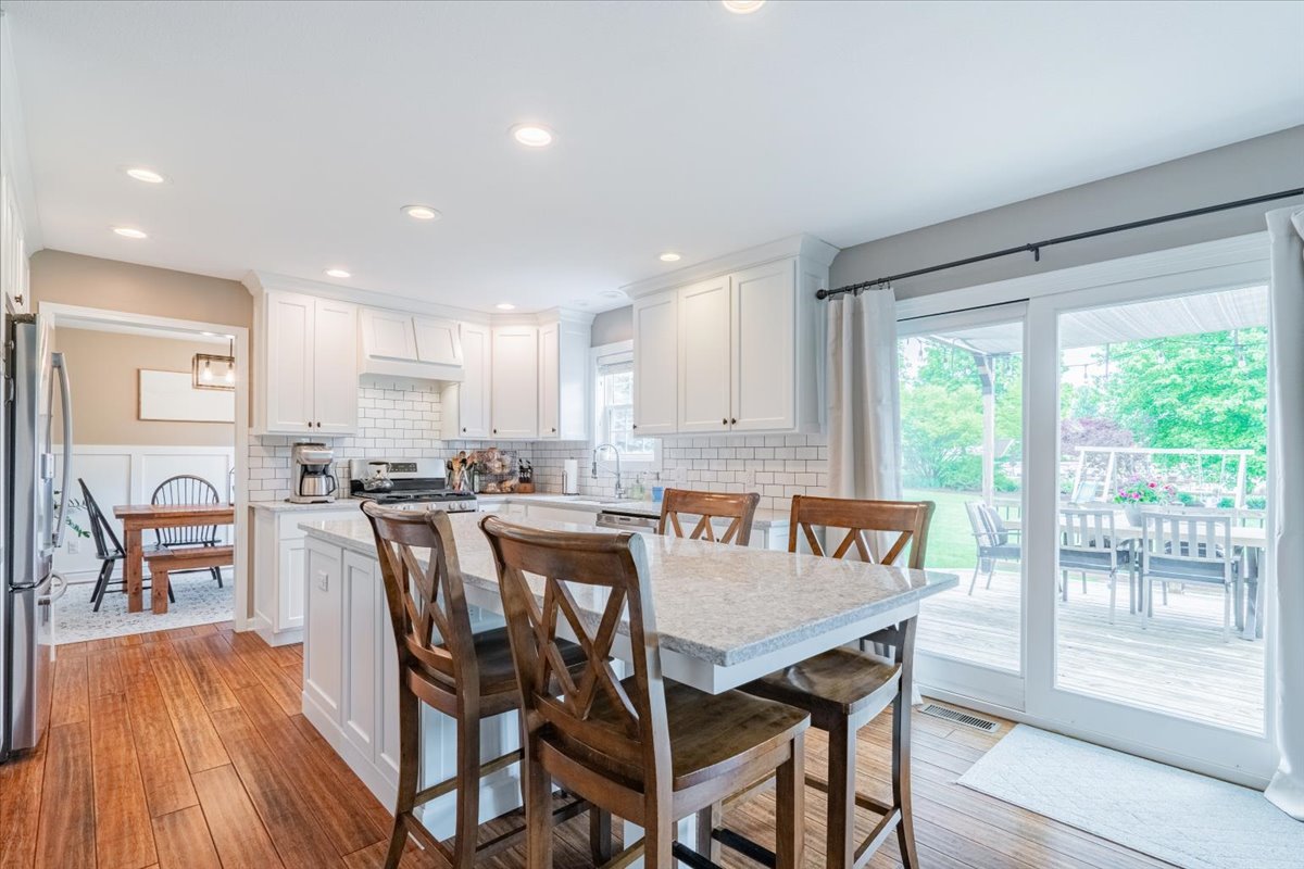 13561 Buck Road Bloomington, IL 61705 - Photo 13 of 43 a view of a dining room with furniture window and wooden floor