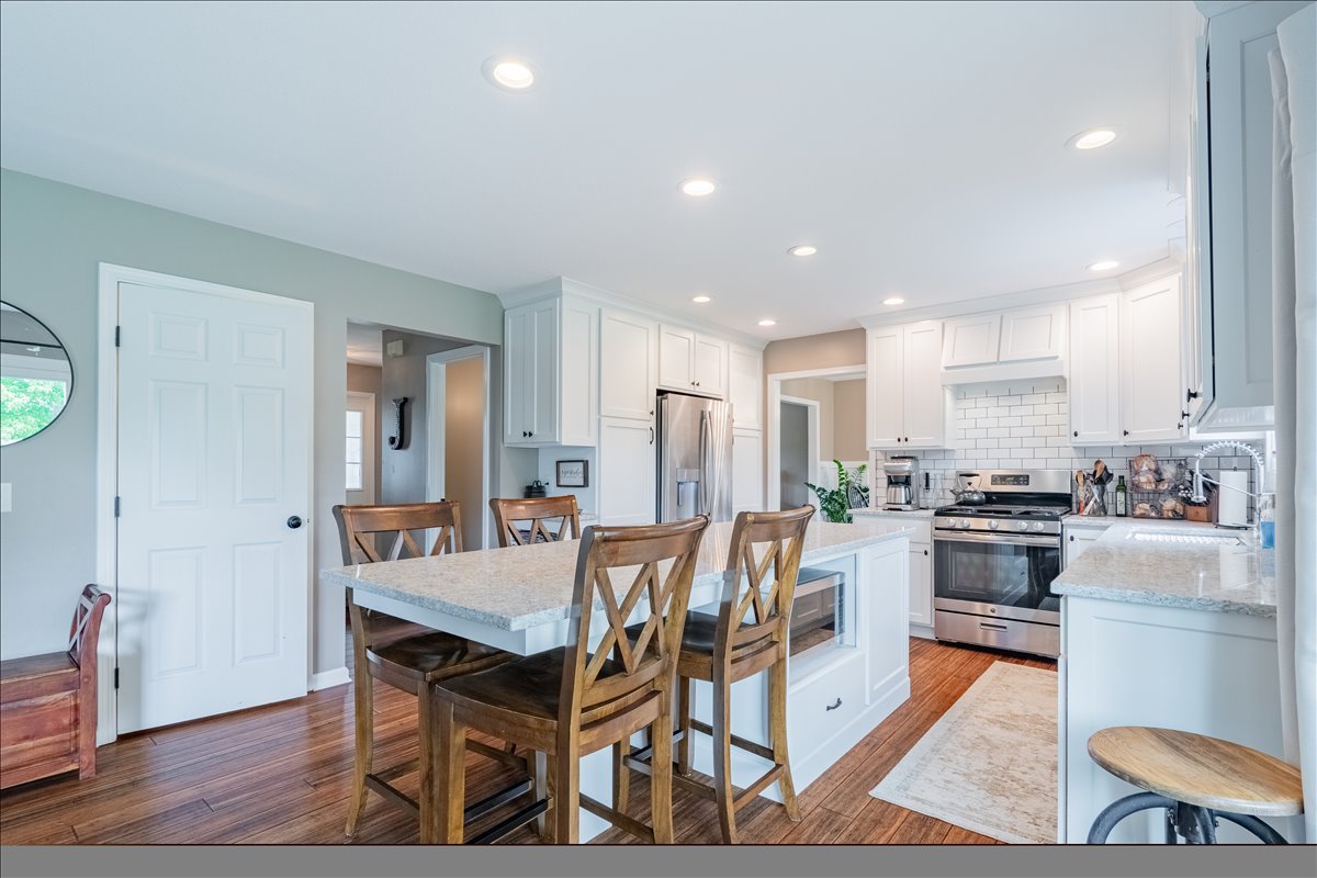 13561 Buck Road Bloomington, IL 61705 - Photo 14 of 43 a view of a dining room with furniture and wooden floor