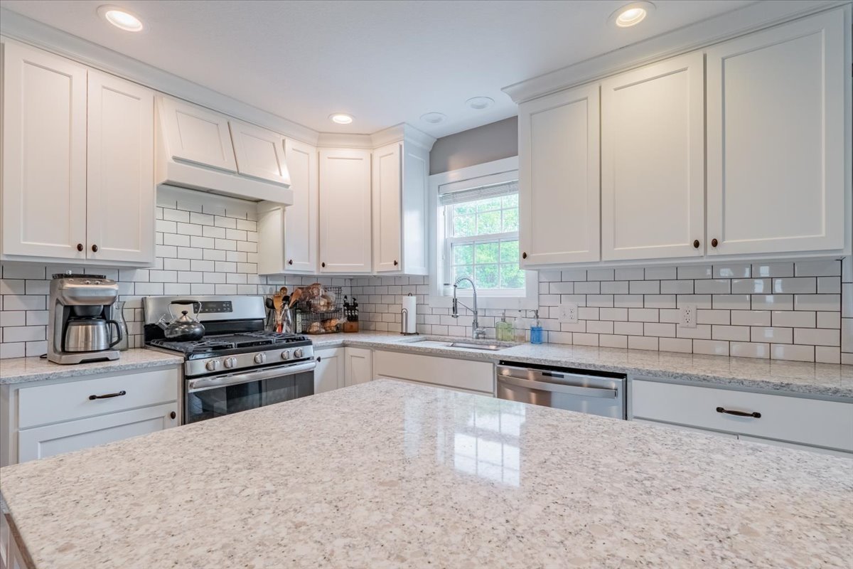 13561 Buck Road Bloomington, IL 61705 - Photo 16 of 43 a kitchen with stainless steel appliances granite countertop a stove a sink and a refrigerator