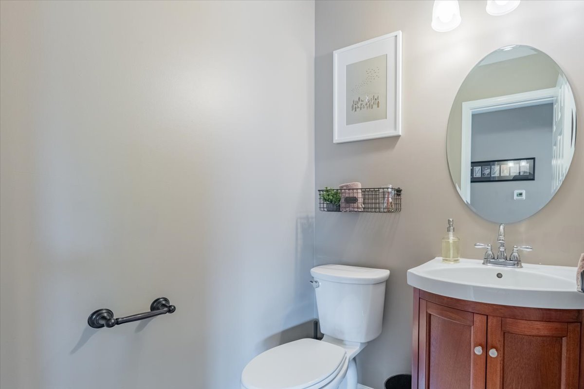 13561 Buck Road Bloomington, IL 61705 - Photo 19 of 43 a bathroom with a toilet a sink and mirror