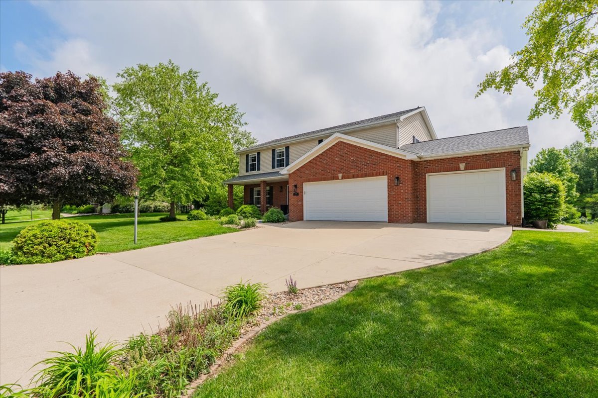 13561 Buck Road Bloomington, IL 61705 - Photo 2 of 43 a front view of a house with a yard and garage