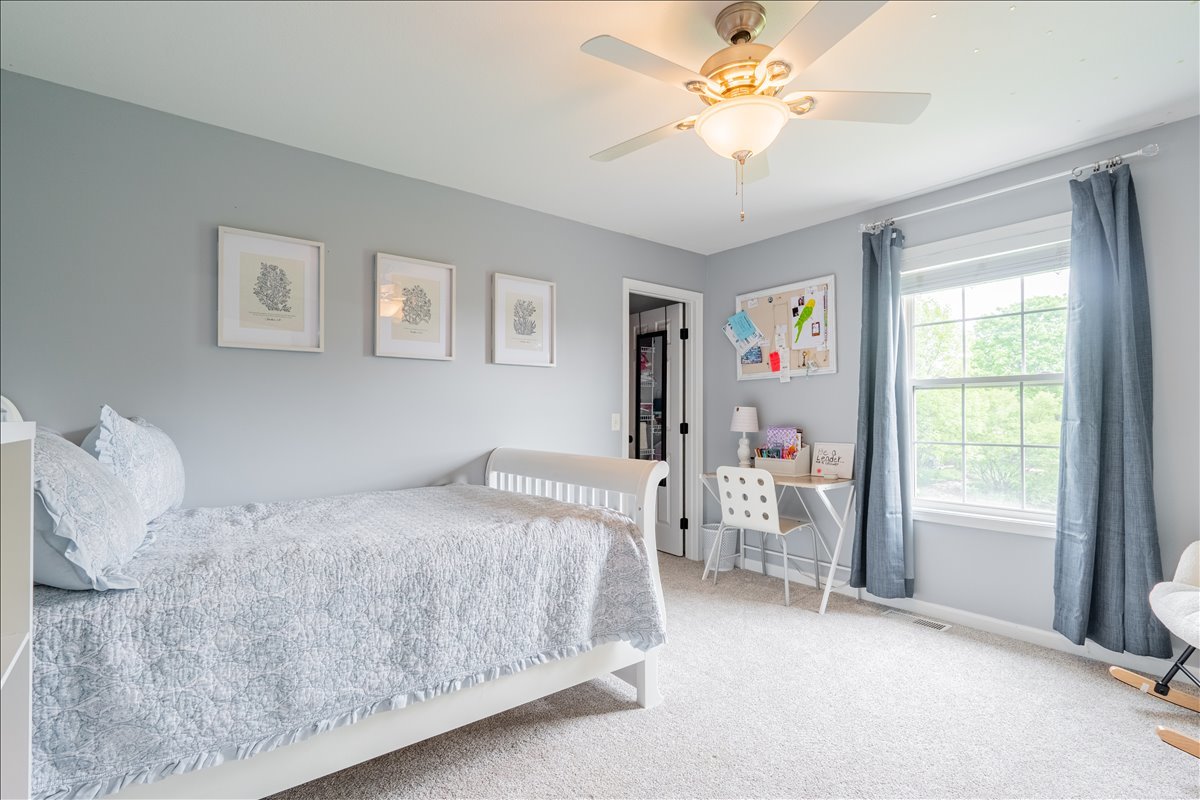 13561 Buck Road Bloomington, IL 61705 - Photo 21 of 43 a bedroom with a bed and a chandelier