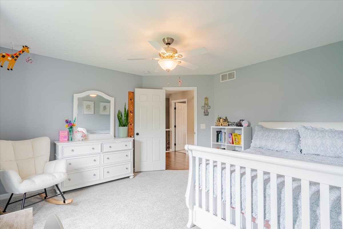 13561 Buck Road Bloomington, IL 61705 - Photo 22 of 43 a bedroom with furniture and wooden floor
