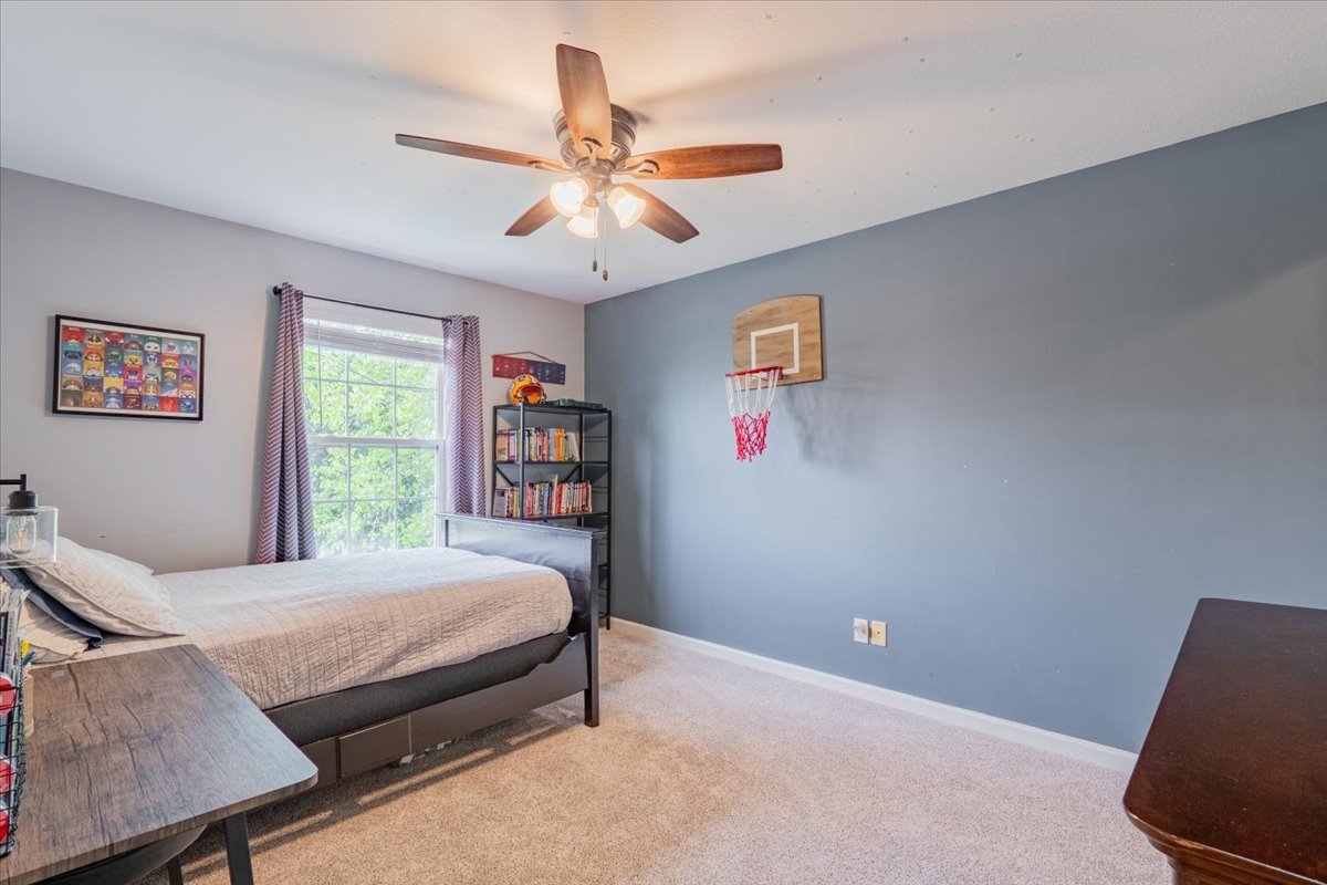 13561 Buck Road Bloomington, IL 61705 - Photo 23 of 43 a bedroom with a bed and a chandelier