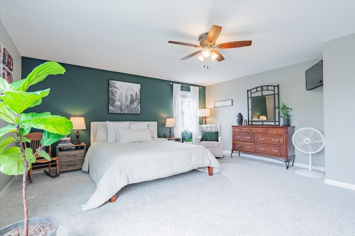 13561 Buck Road Bloomington, IL 61705 - Photo 29 of 43 a bedroom with a bed and a chandelier