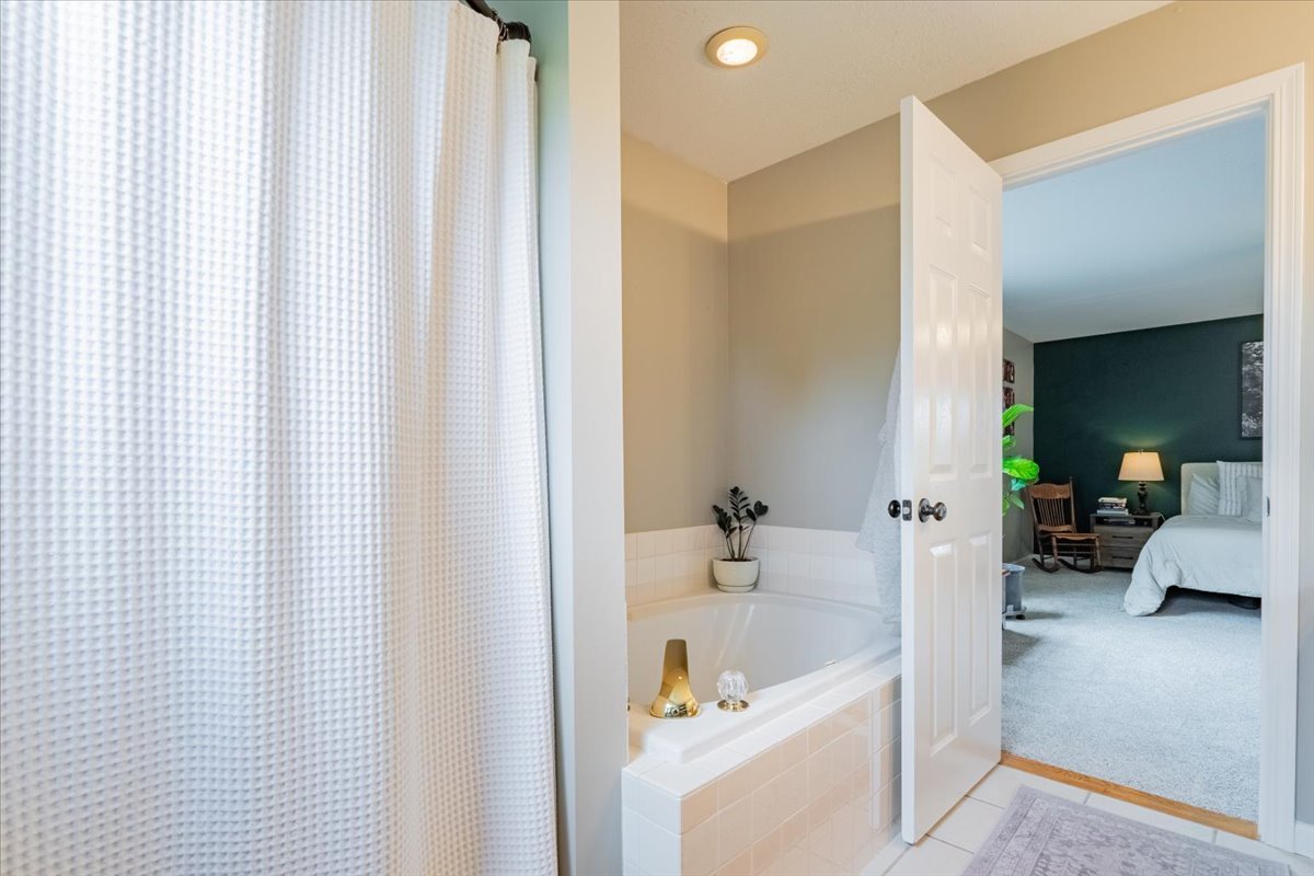 13561 Buck Road Bloomington, IL 61705 - Photo 32 of 43 a en suite bathroom with a bathtub and shower