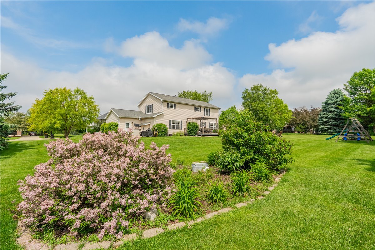 13561 Buck Road Bloomington, IL 61705 - Photo 42 of 43 a view of a garden with a building in the background