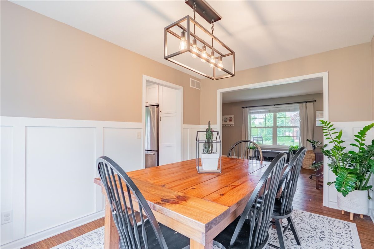 13561 Buck Road Bloomington, IL 61705 - Photo 10 of 43 a view of a dining room with furniture window and wooden floor