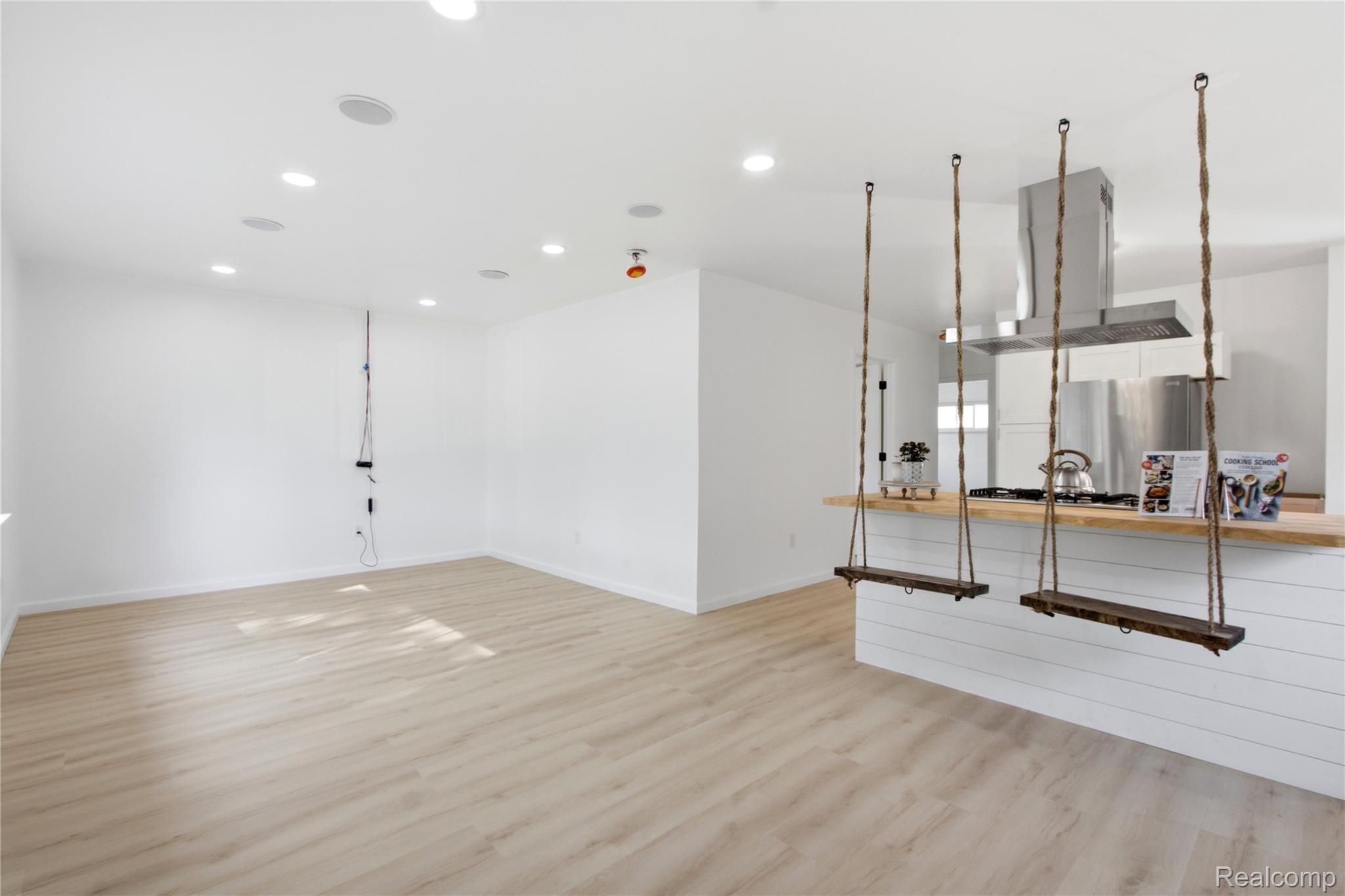 Open layout of living room/kitchen area with Huge island and swing seating