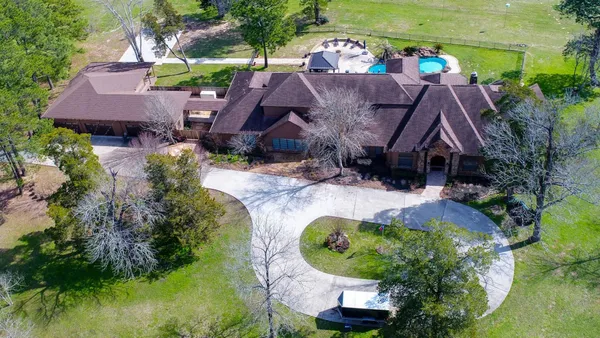 an aerial view of house with swimming pool outdoor seating and yard