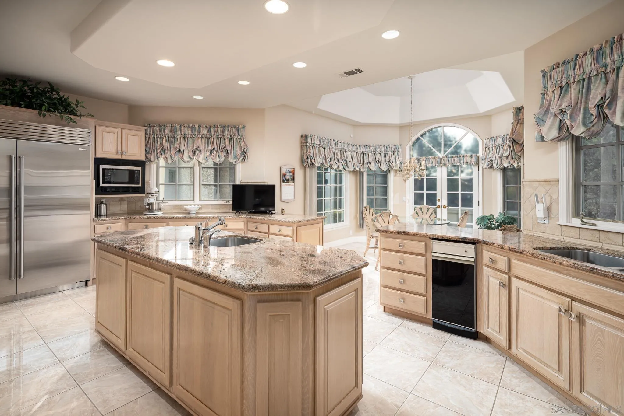 18221 Via Ascenso Rancho Santa Fe, CA 92067 - Photo 15 of 37 a kitchen with stainless steel appliances granite countertop a sink and cabinets