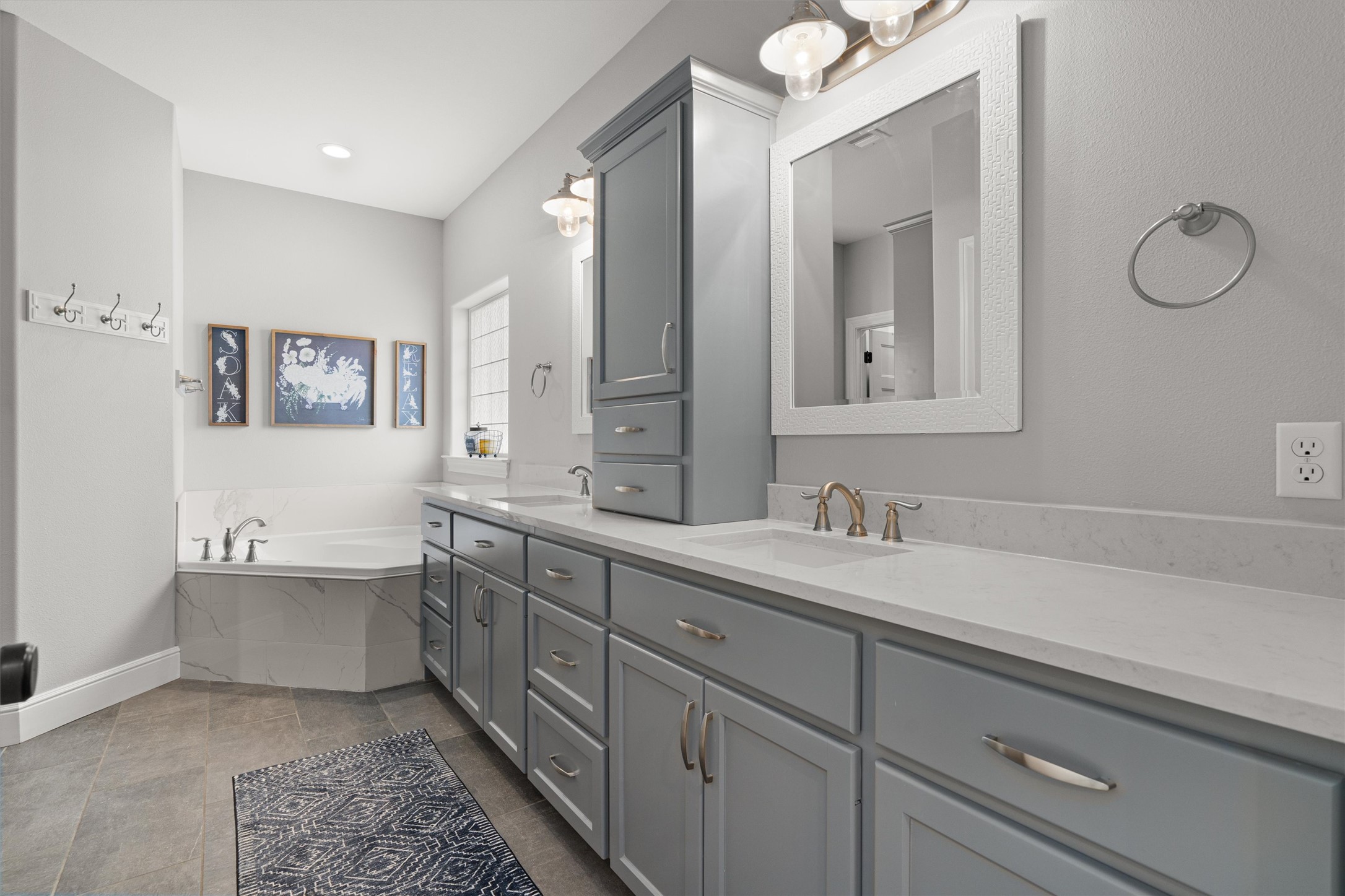 136 Fawn Hollow Elgin, TX 78621 - Photo 17 of 40 Primary expansive bathroom featuring dual vanity with gray cabinetry and white countertops
